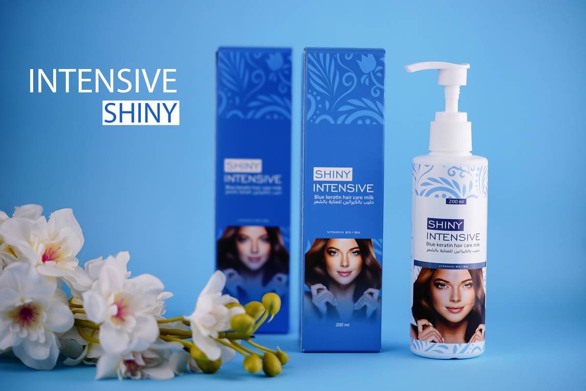 Close-up of hands applying hydrating hair gel to damp curls for definition and moisture